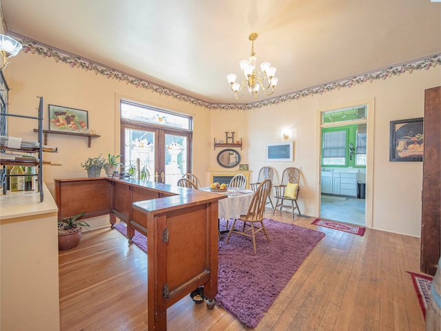 office area featuring french doors, a chandelier, and light wood-type flooring