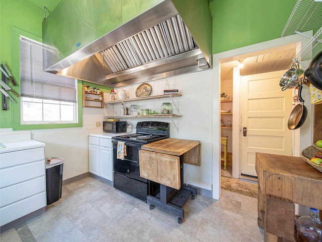 kitchen with premium range hood, white cabinetry, and black appliances