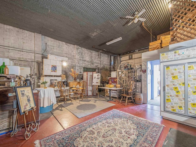 miscellaneous room featuring concrete flooring and ceiling fan