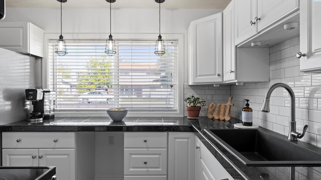 2404 Camden St, Richland, WA 99352 - kitchen with a sink, white cabinetry, tile countertops, decorative backsplash, and pendant lighting