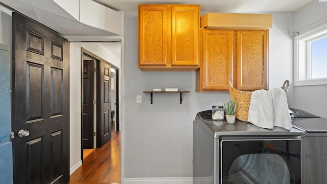 2404 Camden St, Richland, WA 99352 - laundry room with cabinet space, washing machine and dryer, dark wood-style floors, and baseboards