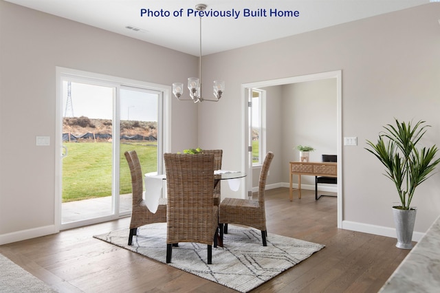 dining area with visible vents, baseboards, dark wood finished floors, and a chandelier