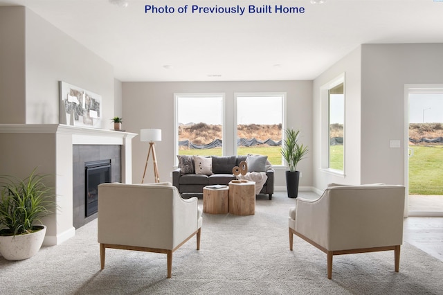 living area with light carpet, a fireplace, and baseboards