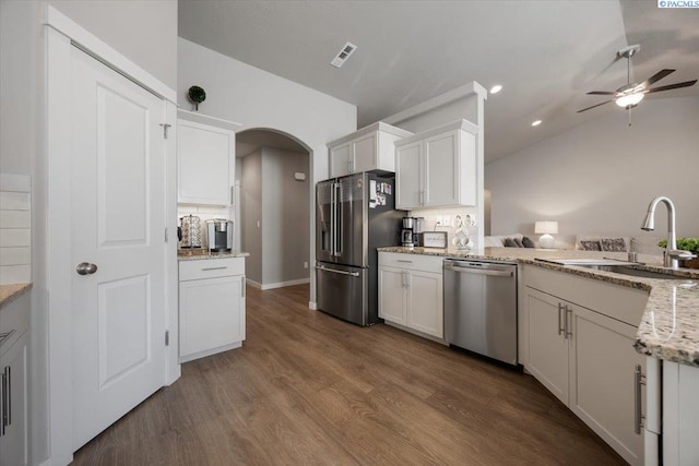 234 Ladera St, Prosser, WA 99350 - kitchen featuring arched walkways, stainless steel appliances, a sink, visible vents, and backsplash