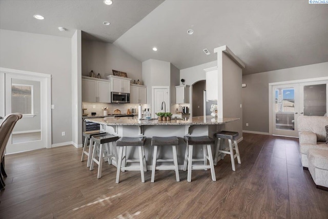 234 Ladera St, Prosser, WA 99350 - kitchen with lofted ceiling, stainless steel microwave, a breakfast bar area, and french doors
