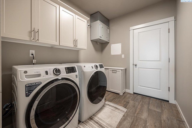 234 Ladera St, Prosser, WA 99350 - washroom with baseboards, wood finished floors, cabinet space, and washer and dryer