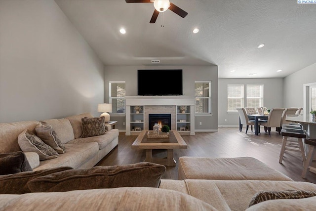 234 Ladera St, Prosser, WA 99350 - living area with baseboards, a tile fireplace, lofted ceiling, wood finished floors, and recessed lighting