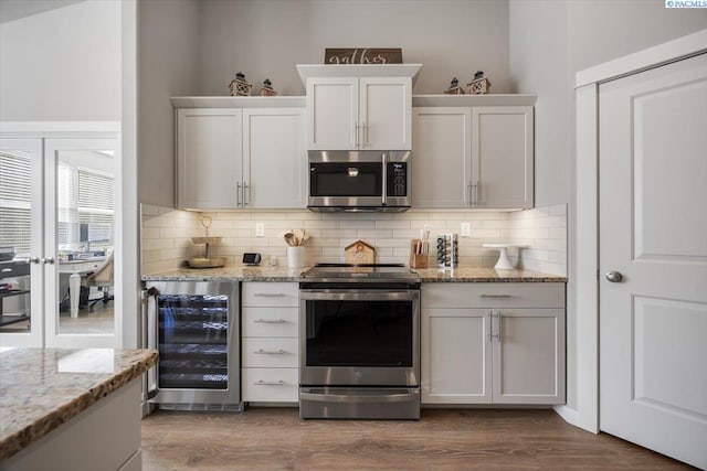 234 Ladera St, Prosser, WA 99350 - bar with stainless steel appliances, wine cooler, dark wood-style flooring, and decorative backsplash