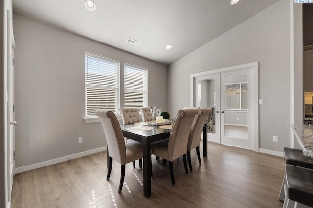 234 Ladera St, Prosser, WA 99350 - dining area with lofted ceiling, french doors, visible vents, and wood finished floors