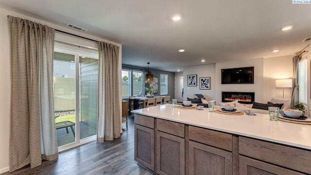 643 S Zeelar St, Kennewick, WA 99336 - kitchen featuring dark wood-type flooring, open floor plan, recessed lighting, light countertops, and a glass covered fireplace