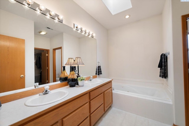 104 Center Blvd, Richland, WA 99352 - bathroom featuring a skylight, double vanity, a garden tub, and tile patterned flooring