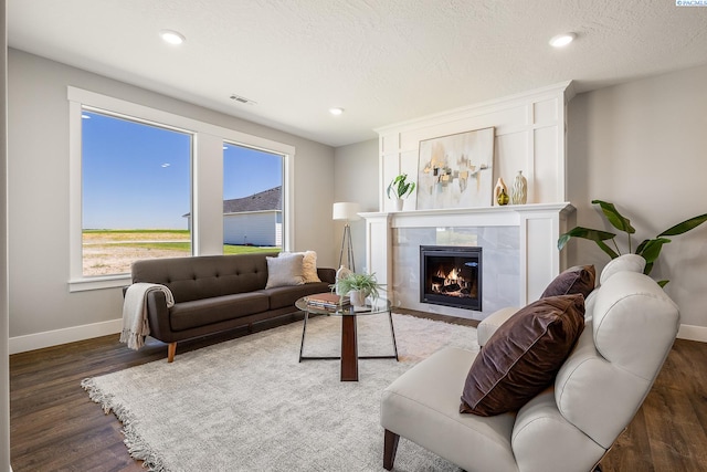 7080 W 34th Pl, Kennewick, WA 99338 - living room featuring baseboards, a fireplace, wood finished floors, a textured ceiling, and recessed lighting