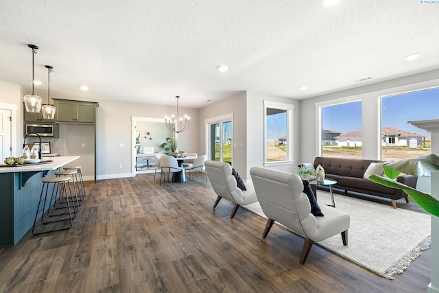 7080 W 34th Pl, Kennewick, WA 99338 - living area featuring dark wood finished floors, a chandelier, baseboards, plenty of natural light, and recessed lighting