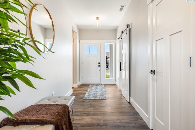 7080 W 34th Pl, Kennewick, WA 99338 - foyer entrance with a barn door, dark wood-style flooring, and baseboards