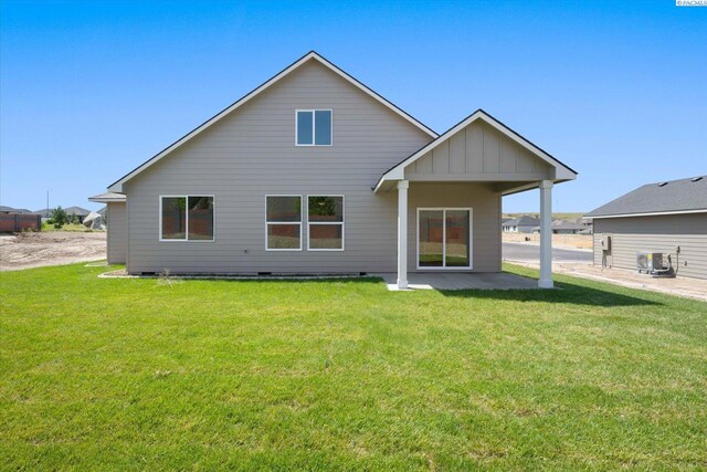 7136 W 28th Pl, Kennewick, WA 99338 - rear view of house with a lawn, a patio area, and board and batten siding