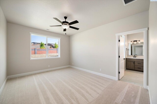 7136 W 28th Pl, Kennewick, WA 99338 - unfurnished bedroom with light colored carpet, ensuite bath, and a ceiling fan