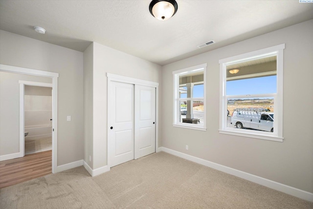 7136 W 28th Pl, Kennewick, WA 99338 - unfurnished bedroom with light colored carpet and a closet