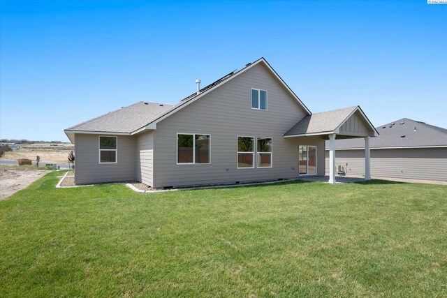 7136 W 28th Pl, Kennewick, WA 99338 - back of property with a lawn, a shingled roof, and a patio