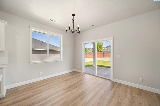 7136 W 28th Pl, Kennewick, WA 99338 - unfurnished dining area with a chandelier and light wood-style flooring