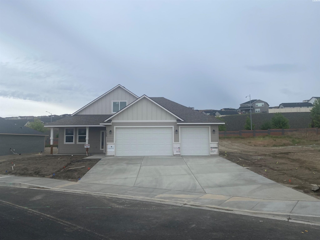 view of front facade featuring an attached garage, board and batten siding, and concrete driveway