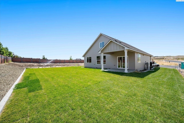 7136 W 28th Pl, Kennewick, WA 99338 - back of property featuring a fenced backyard, a patio area, and board and batten siding