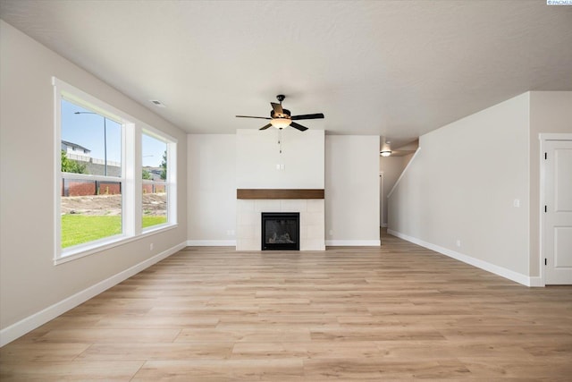 7136 W 28th Pl, Kennewick, WA 99338 - unfurnished living room with ceiling fan, light wood-type flooring, and a tile fireplace