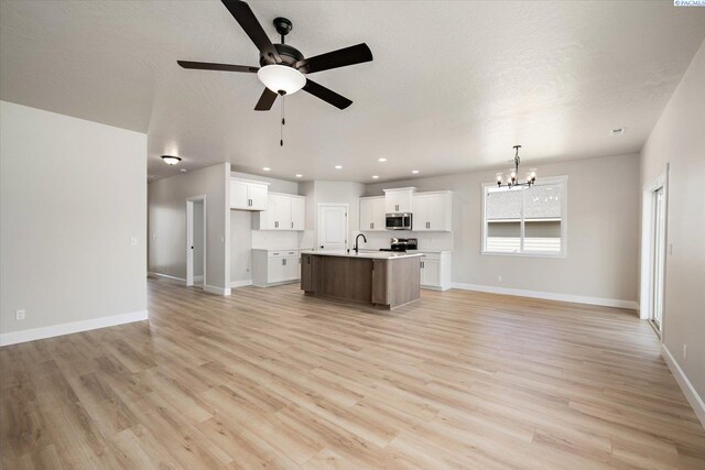 7136 W 28th Pl, Kennewick, WA 99338 - unfurnished living room featuring a chandelier, a ceiling fan, light wood-type flooring, recessed lighting, and a textured ceiling
