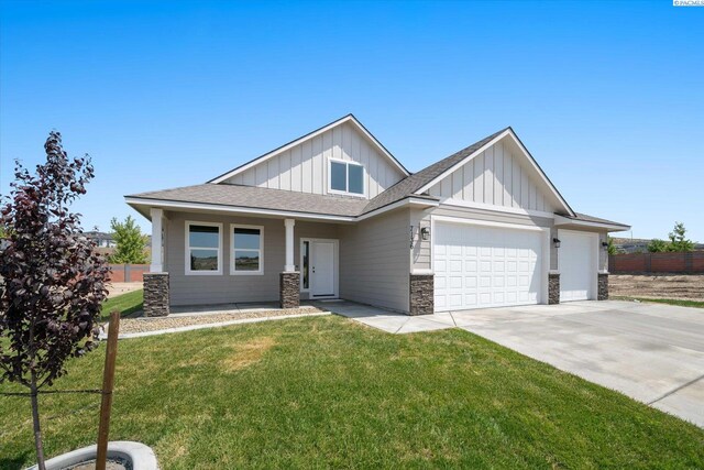 7136 W 28th Pl, Kennewick, WA 99338 - craftsman-style house with board and batten siding, a garage, stone siding, concrete driveway, and roof with shingles