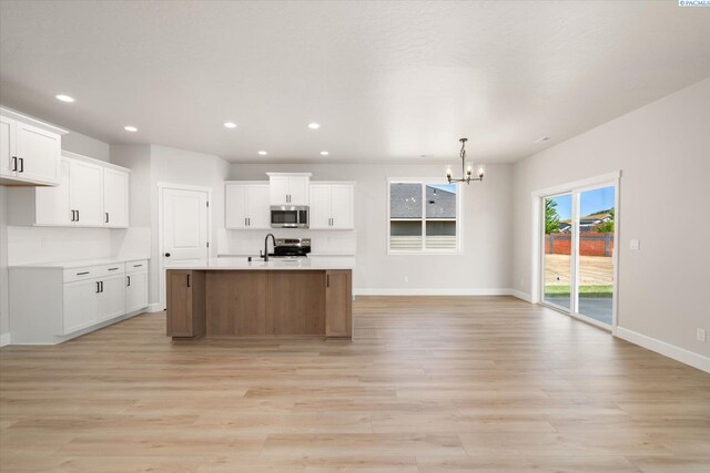 7136 W 28th Pl, Kennewick, WA 99338 - kitchen featuring appliances with stainless steel finishes, a chandelier, light wood finished floors, and recessed lighting