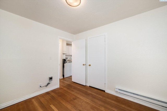 1205 N Union St, Kennewick, WA 99336 - spare room with a baseboard radiator, wood finished floors, and baseboards
