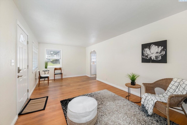 1205 N Union St, Kennewick, WA 99336 - living room with arched walkways, wood finished floors, and baseboards