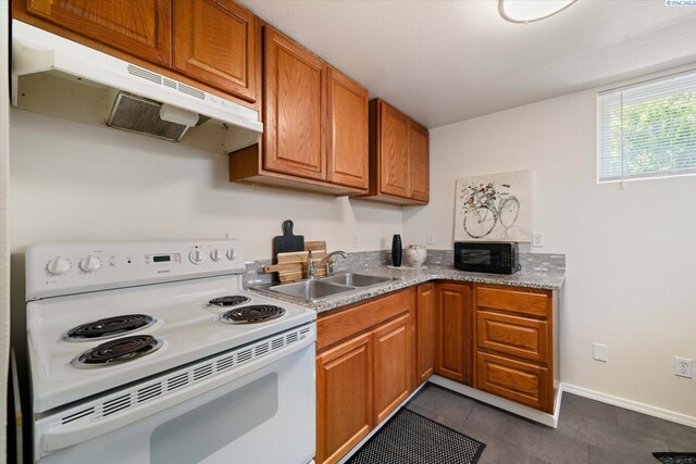 1205 N Union St, Kennewick, WA 99336 - kitchen featuring white electric range, under cabinet range hood, a sink, black microwave, and brown cabinets