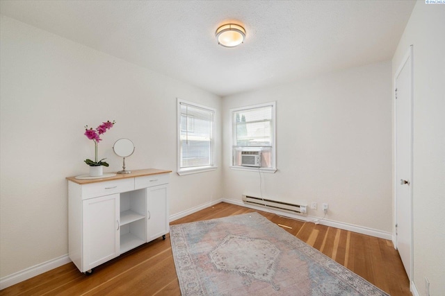 1205 N Union St, Kennewick, WA 99336 - spare room with a baseboard heating unit, wood finished floors, and baseboards