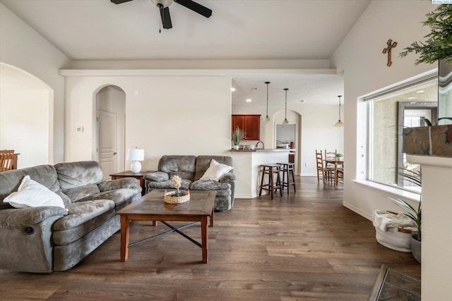 living room with dark wood-type flooring and ceiling fan