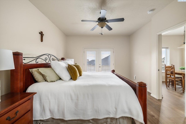 bedroom featuring hardwood / wood-style flooring, access to exterior, ceiling fan, a textured ceiling, and french doors