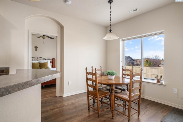 dining area with dark hardwood / wood-style flooring and ceiling fan