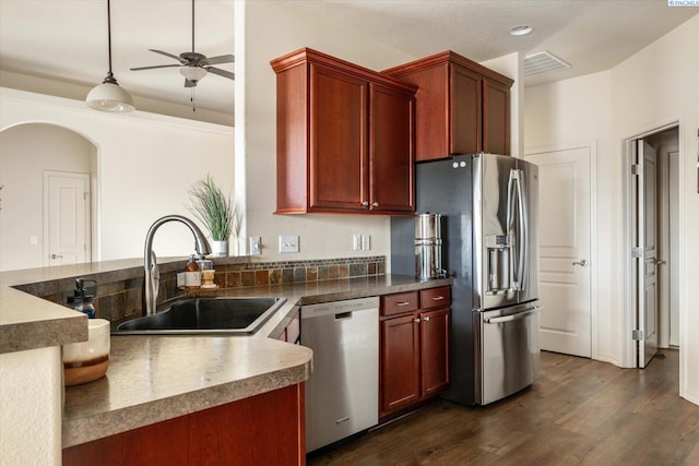 kitchen featuring sink, ceiling fan, appliances with stainless steel finishes, hanging light fixtures, and dark hardwood / wood-style floors