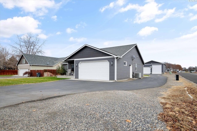 view of side of property featuring cooling unit and a garage