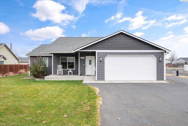 view of front of home with a garage, a porch, and a front yard