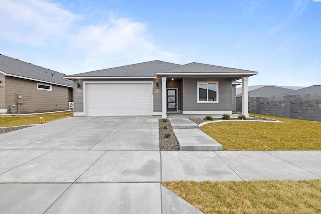 view of front of property with a garage and a front yard