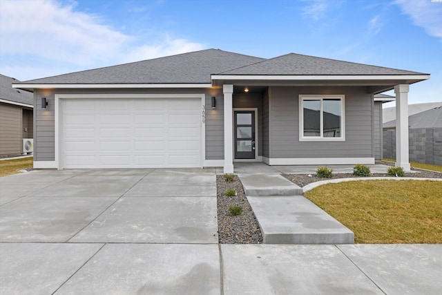 view of front of property with a garage and a front yard