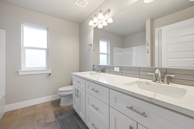 full bathroom featuring a wealth of natural light, visible vents, and a sink