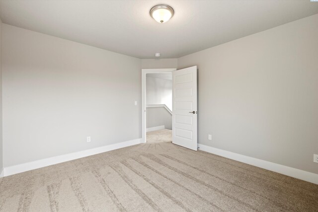 spare room with carpet floors and baseboards