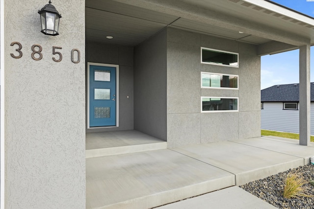 doorway to property with stucco siding