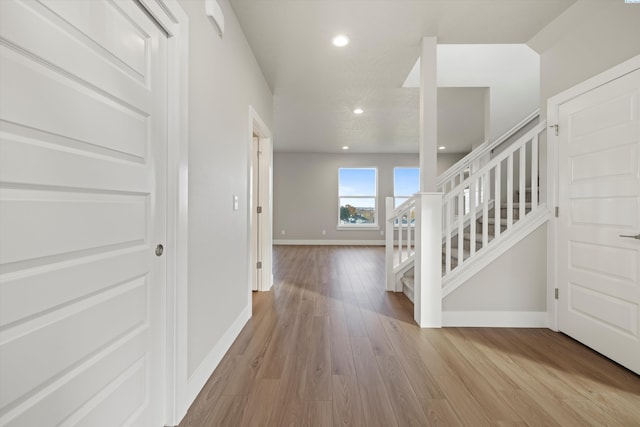 interior space with light wood-style floors, stairs, baseboards, and recessed lighting