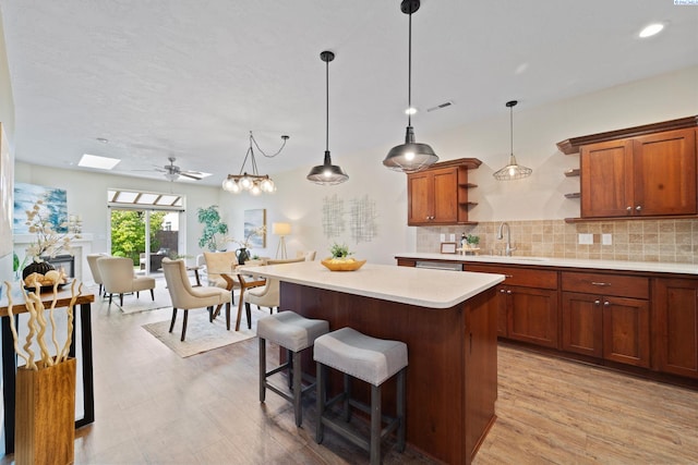 9411 Vincenzo Dr, Pasco, WA 99301 - kitchen featuring open shelves, light countertops, a kitchen island, decorative backsplash, and decorative light fixtures