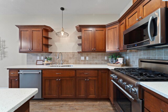 9411 Vincenzo Dr, Pasco, WA 99301 - kitchen featuring appliances with stainless steel finishes, open shelves, tasteful backsplash, decorative light fixtures, and light wood-type flooring