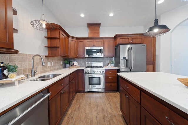 9411 Vincenzo Dr, Pasco, WA 99301 - kitchen featuring appliances with stainless steel finishes, open shelves, tasteful backsplash, light wood finished floors, and recessed lighting