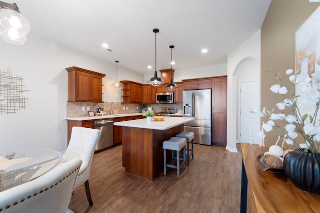 9411 Vincenzo Dr, Pasco, WA 99301 - kitchen with appliances with stainless steel finishes, a center island, decorative backsplash, open shelves, and light countertops