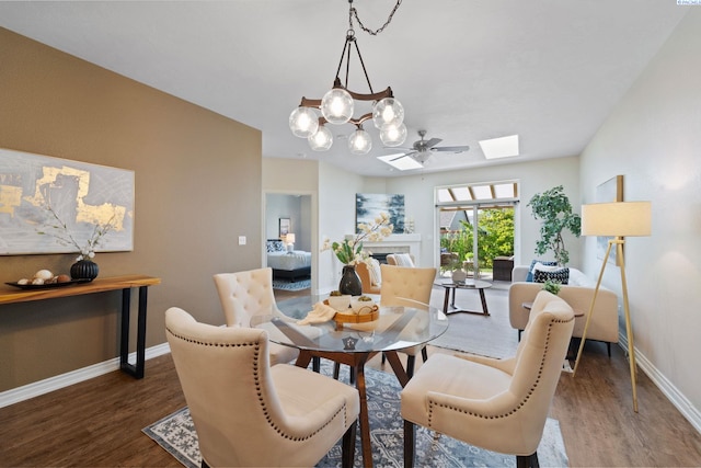 9411 Vincenzo Dr, Pasco, WA 99301 - dining area with wood finished floors, a skylight, a tile fireplace, and a chandelier